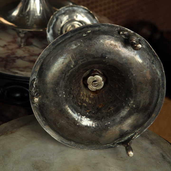 Close-up of the base of a European silver candlestick from Collection EE10 showing aged patina and detailed craftsmanship