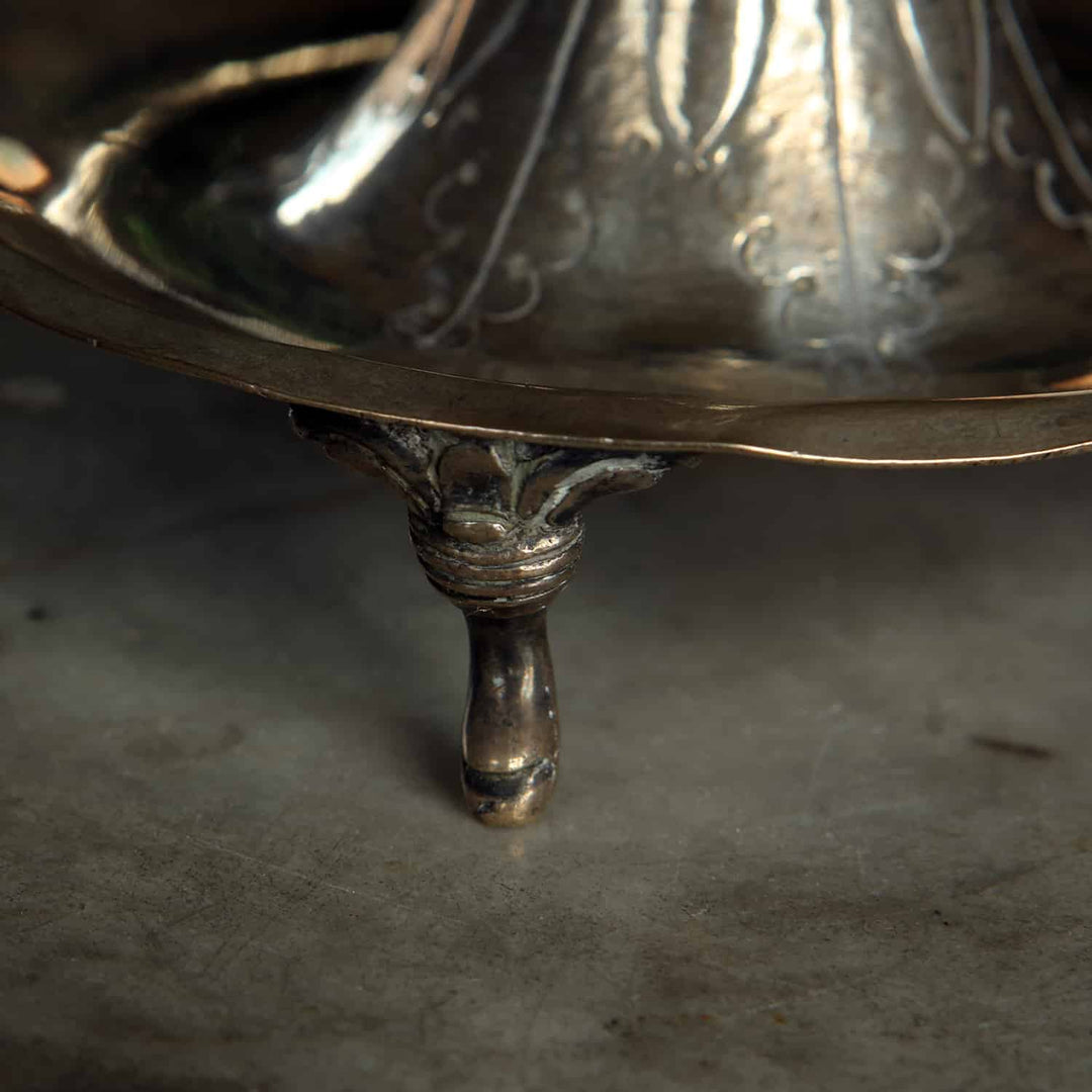 Close-up of scroll foot on a European silver candlestick from Collection EE10 with detailed foliate design