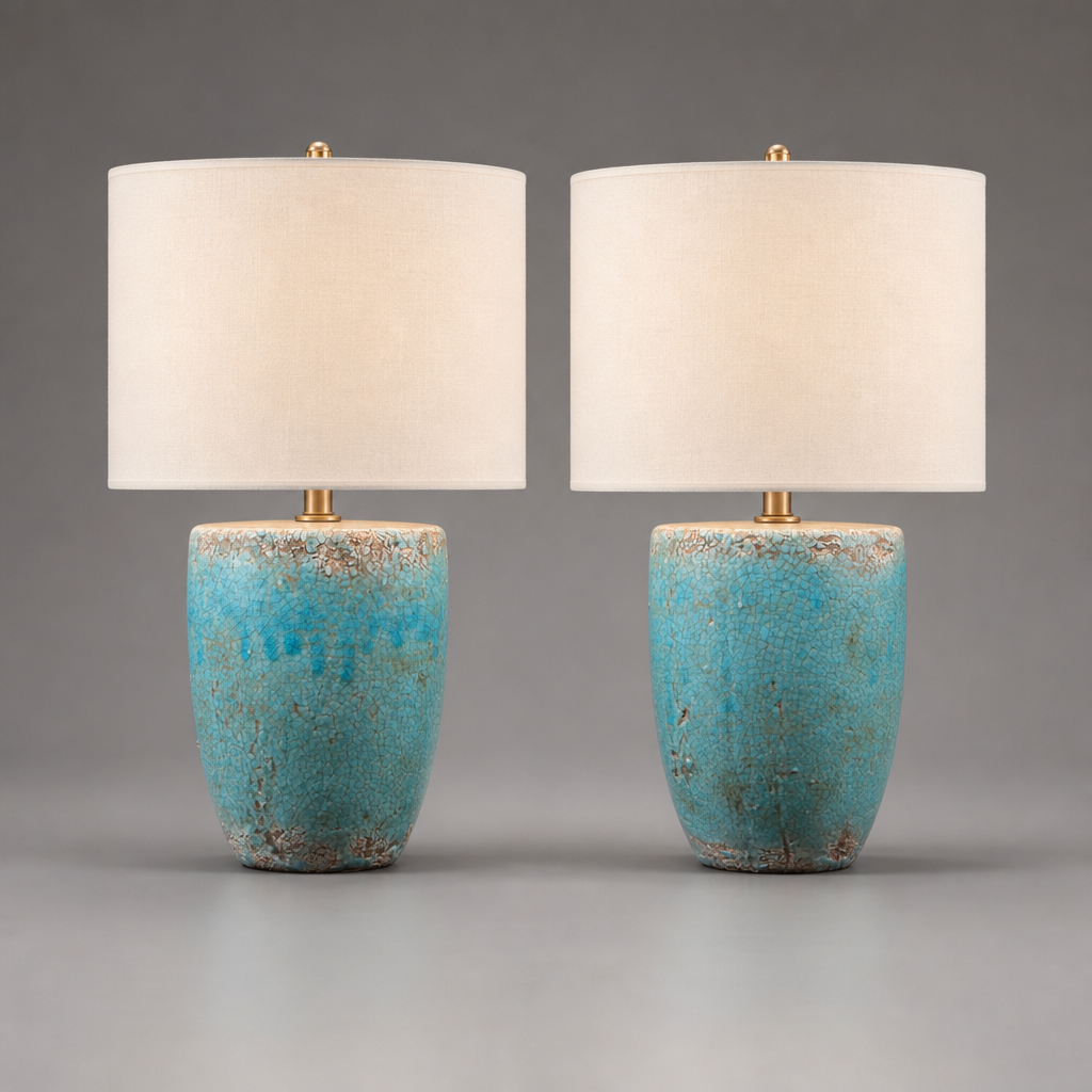 Two table lamps with turquoise bases and white shades on a gray background
