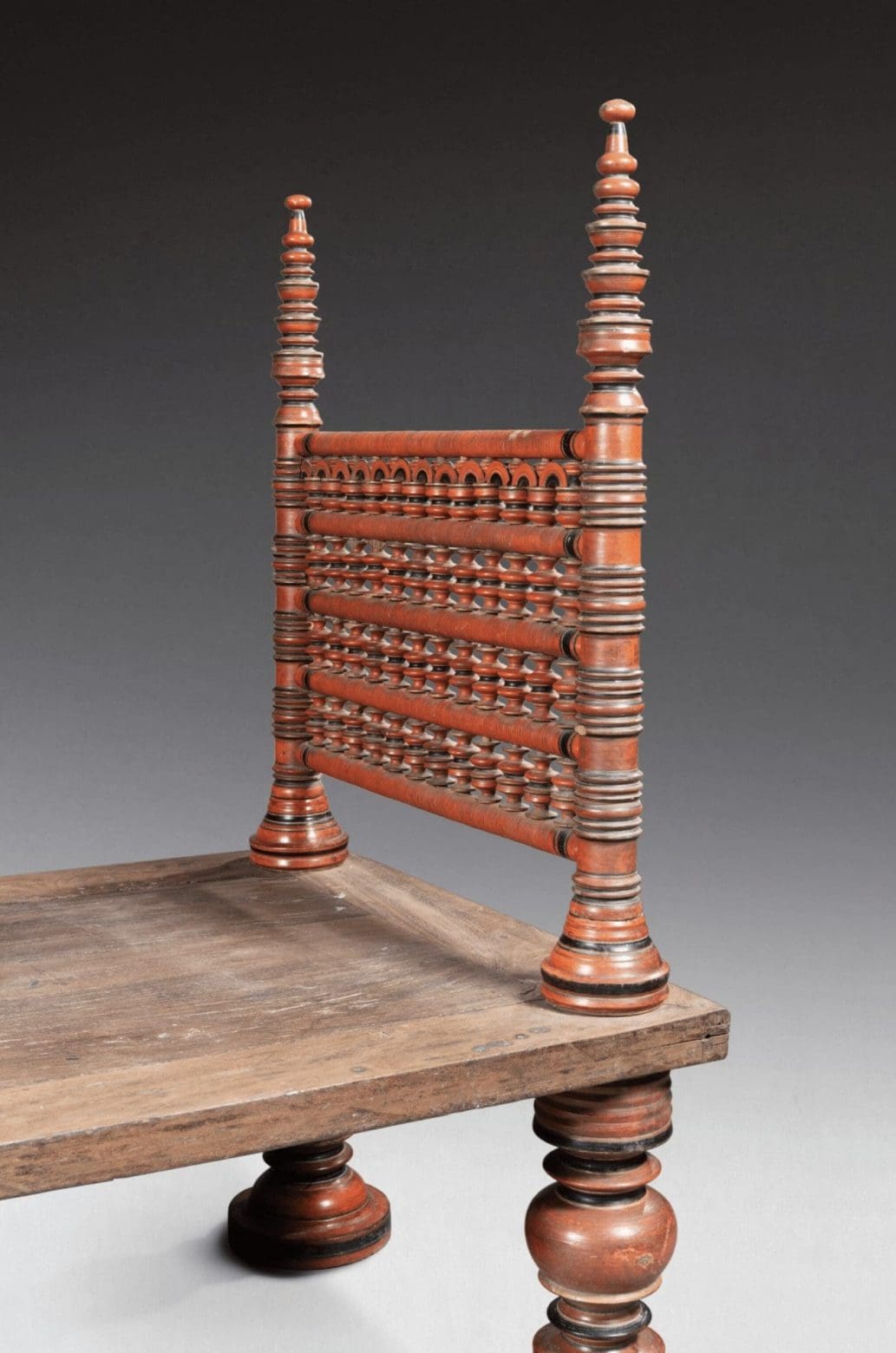 Close-up of finely turned red lacquered wooden headboard on 18th century South Indian bed Collection EE20