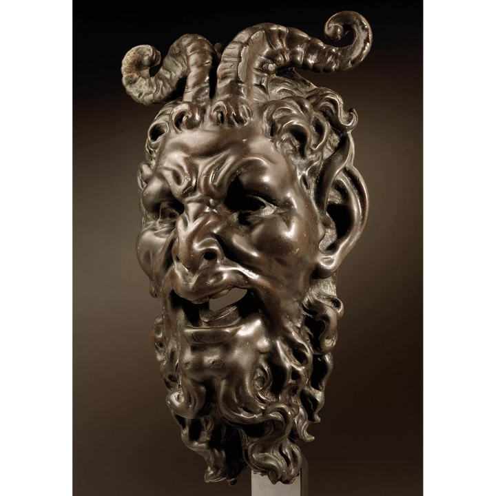 Bronze mask of a Satyr Fountain Head with curled horns and detailed beard, patinated bronze, mounted on a stand.