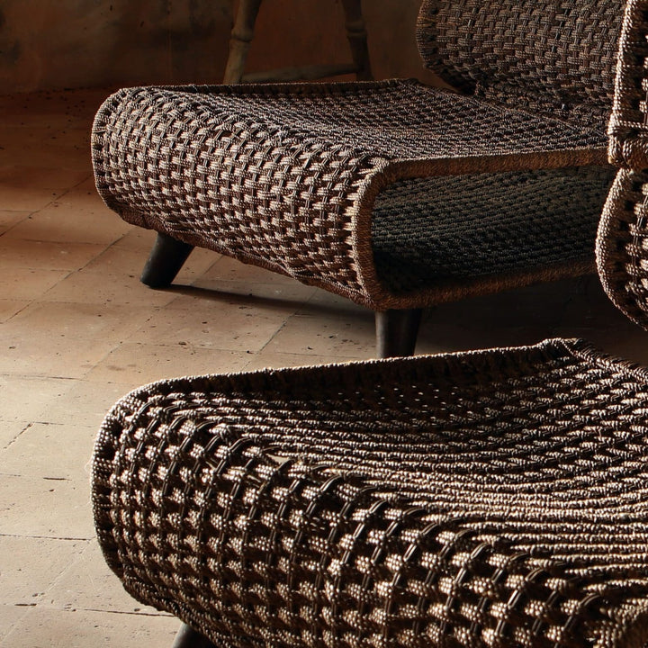 Close-up of two woven seagrass modernist easy chairs with metal legs from Collection EE30