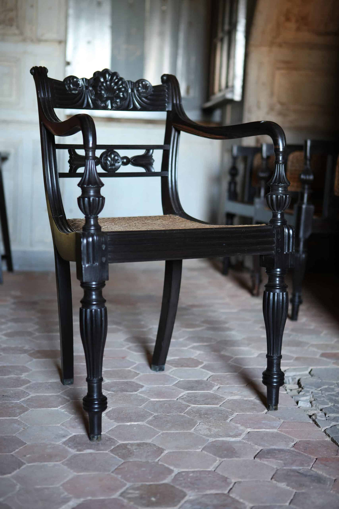 Elegant Anglo-Indian Ceylonese ebony armchair with cane seat and intricate carved details by Collection EE30