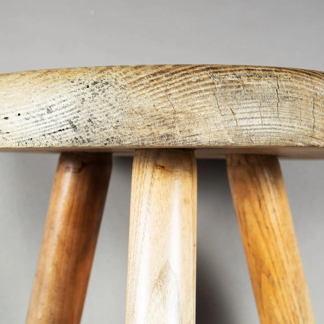 Close-up of turned ash wood legs and seat of Charlotte Perriand Berger Stool by Collection EE30, circa 1960.