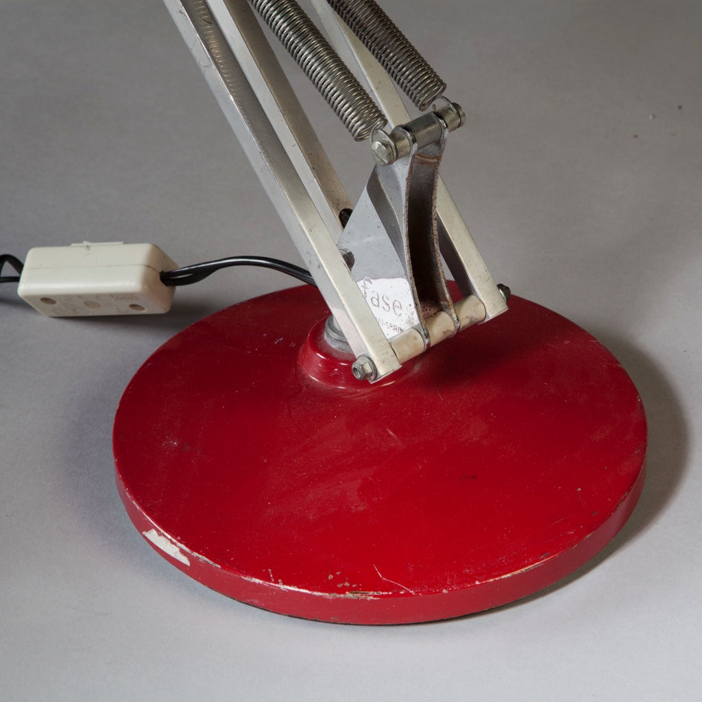 Close-up of the red base and adjustable arm of a vintage Spanish anglepoise lamp by FASE Collection TH10