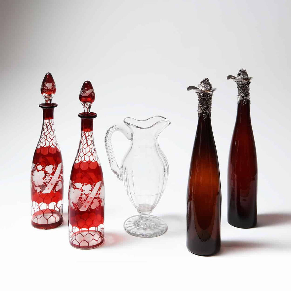 A Pair of Silver Mounted 19th Century Bottles with Victorian design from Collection TH10 displayed with a clear glass pitcher