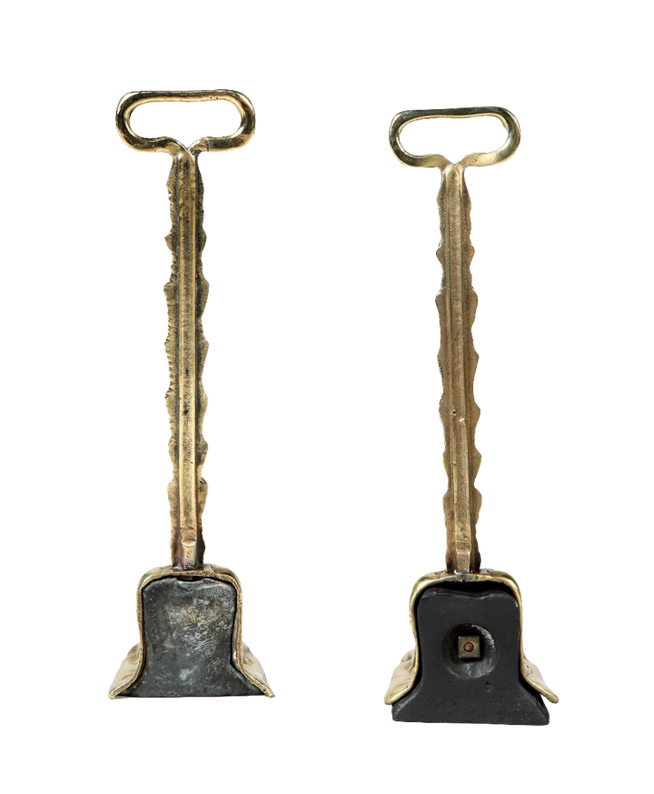 Pair of 19th century weighted brass door porters by Collection TH10 with intricate Victorian design and functional detail