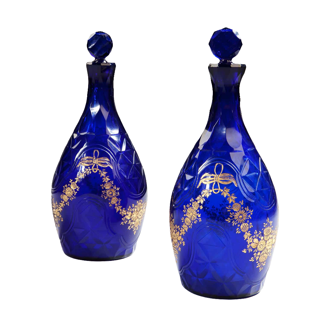 Pair of elegant blue glass facet cut decanters with gold floral design from Collection TH10 showcasing refined craftsmanship
