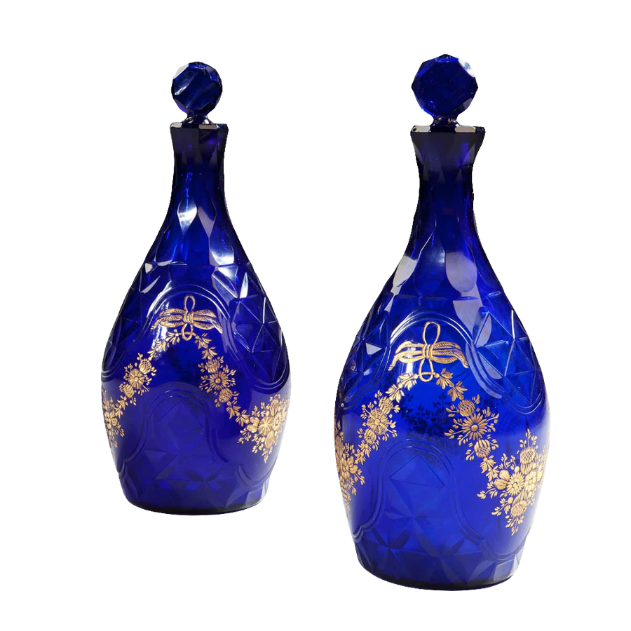 Pair of elegant blue glass facet cut decanters with gold floral design from Collection TH10 showcasing refined craftsmanship