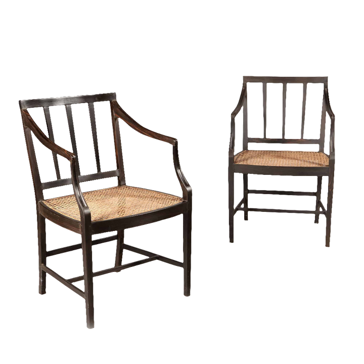 Two solid ebony Anglo Indian dining chairs with caned seats by Collection EE30, circa 2000 craftsmanship.