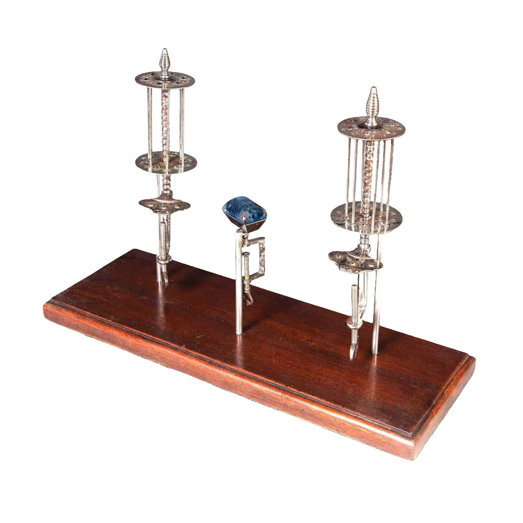 A Group Of Cut Steel Plombieres needlework accessories from Collection TH20 on a wooden display stand.