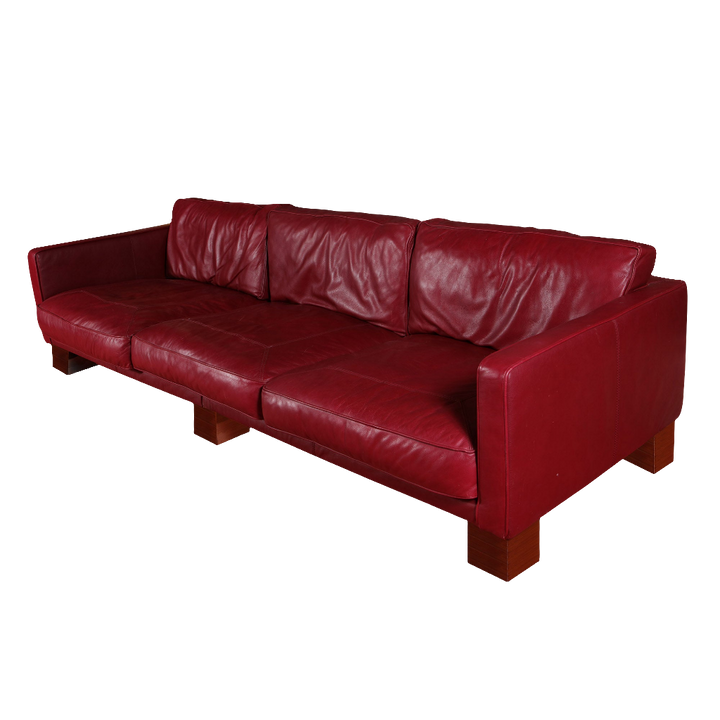 20th Century red leather sofa by Collection NE10 with maroon upholstery and mahogany block feet, seating three comfortably.
