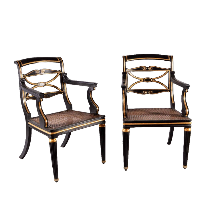 A pair of Regency parcel gilt armchairs with cane seats and brass feet from Collection TH20.