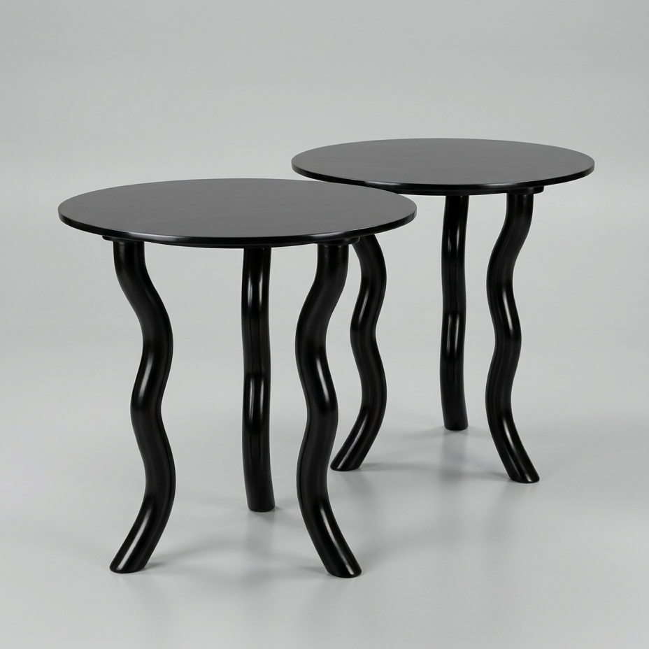 A pair of ebonised circular end tables