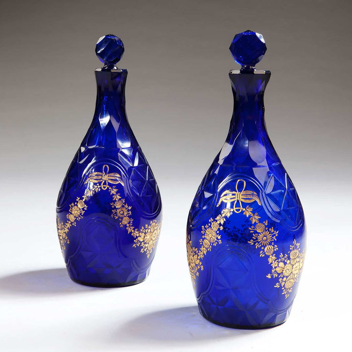 Pair of blue glass facet cut decanters with gold floral design from Collection TH10, elegant Bohemian craftsmanship.
