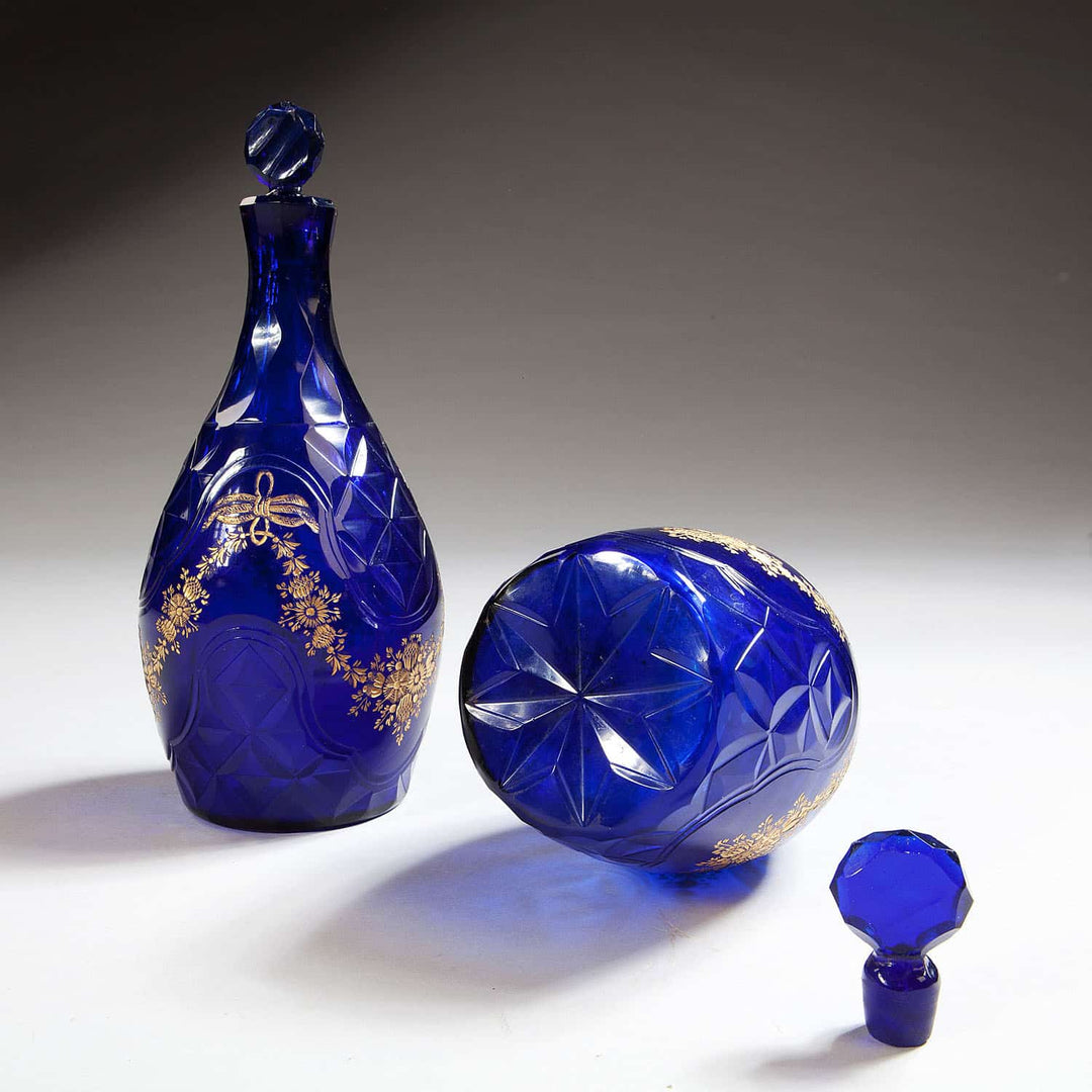 Pair of blue glass facet cut decanters with gold detailing from Collection TH10, showcasing Bohemian artistry