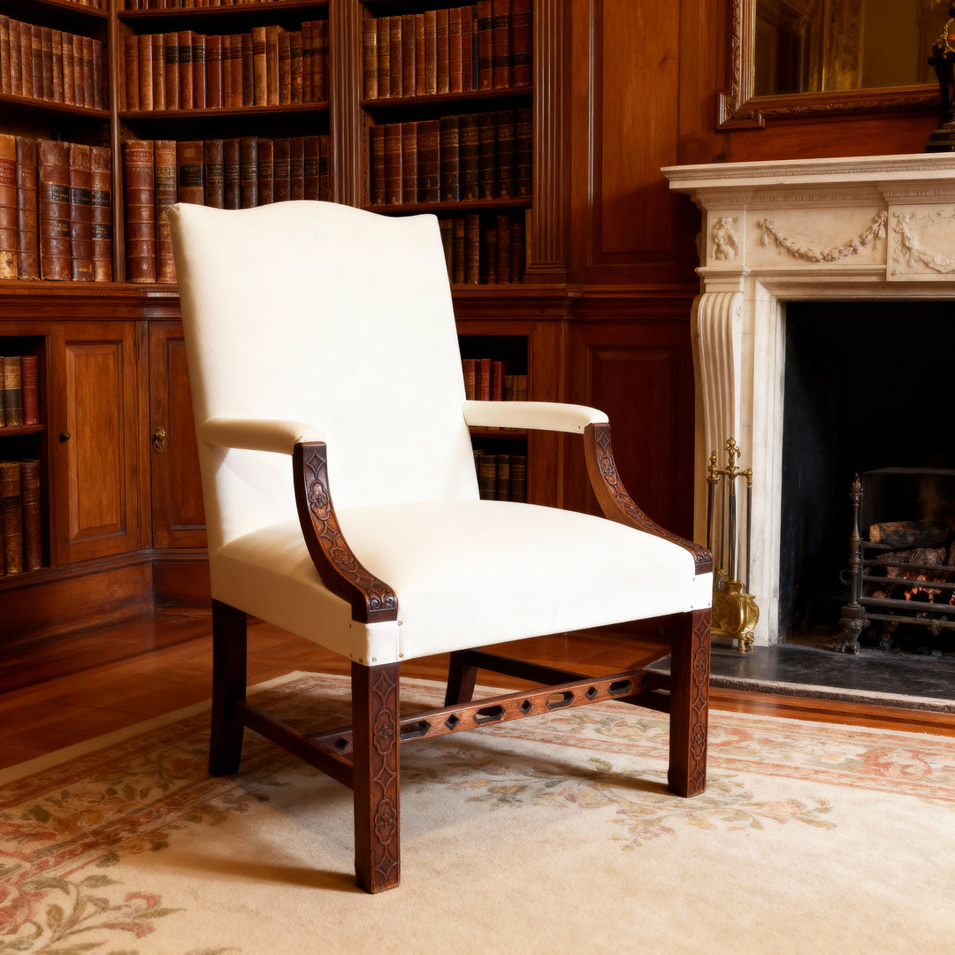 Pair of George III library armchairs with carved wood arms and white upholstery by Collection CK10 in an elegant English library setting