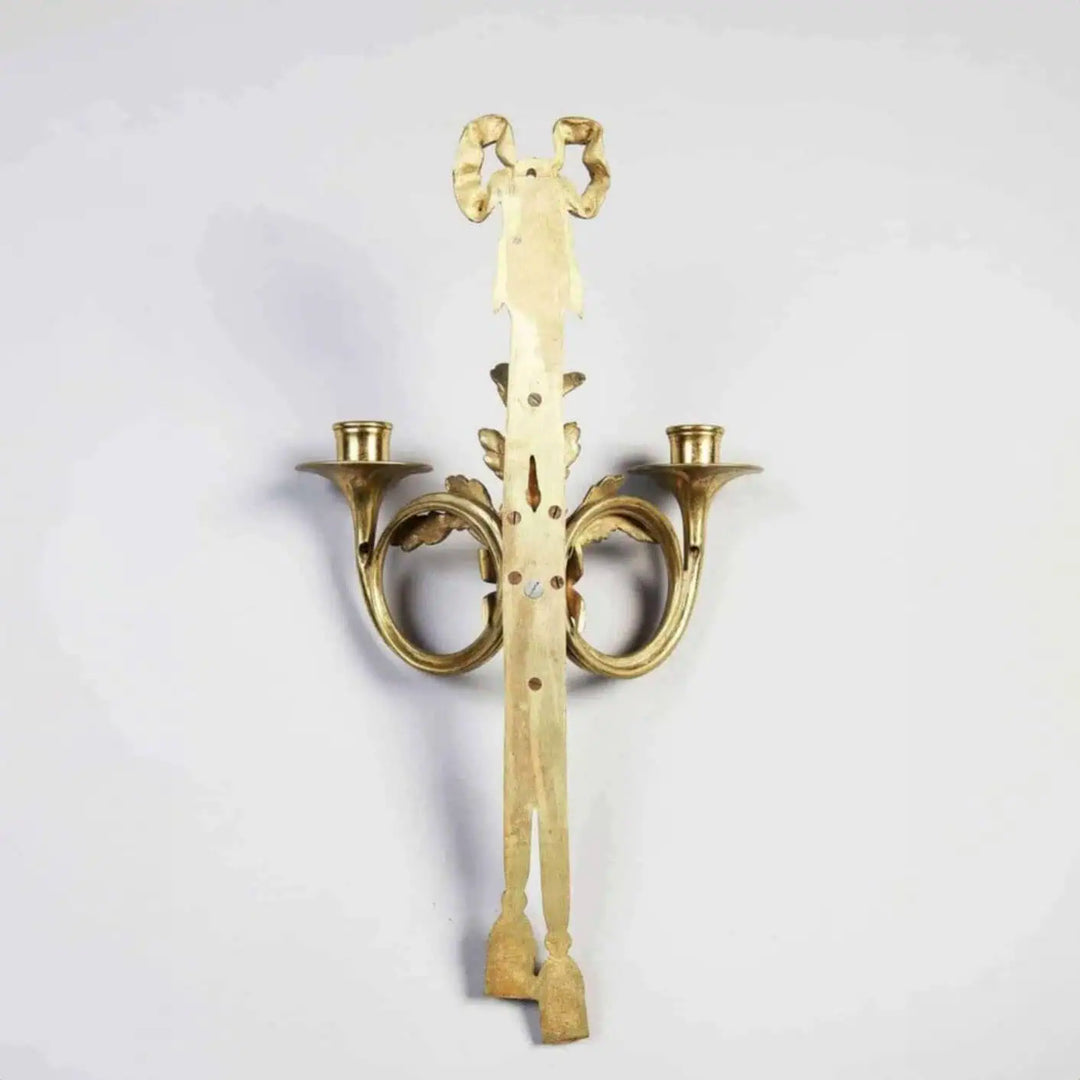 Pair of Louis XVI style gilt-bronze wall lights with two arms shaped as French horns and oak leaf details.