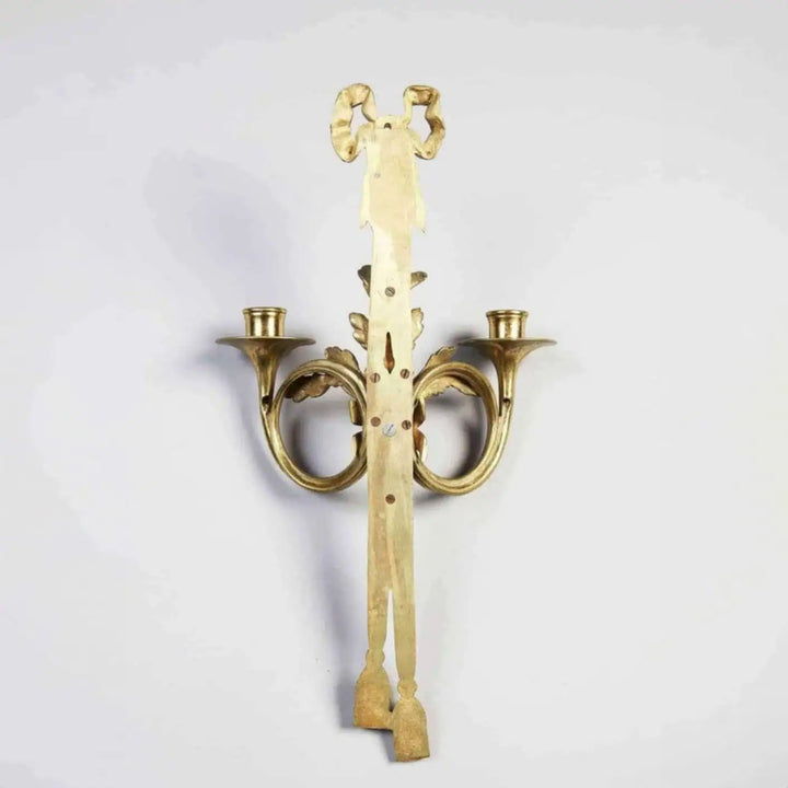 Pair of Louis XVI style gilt-bronze wall lights with two arms shaped as French horns and oak leaf details.