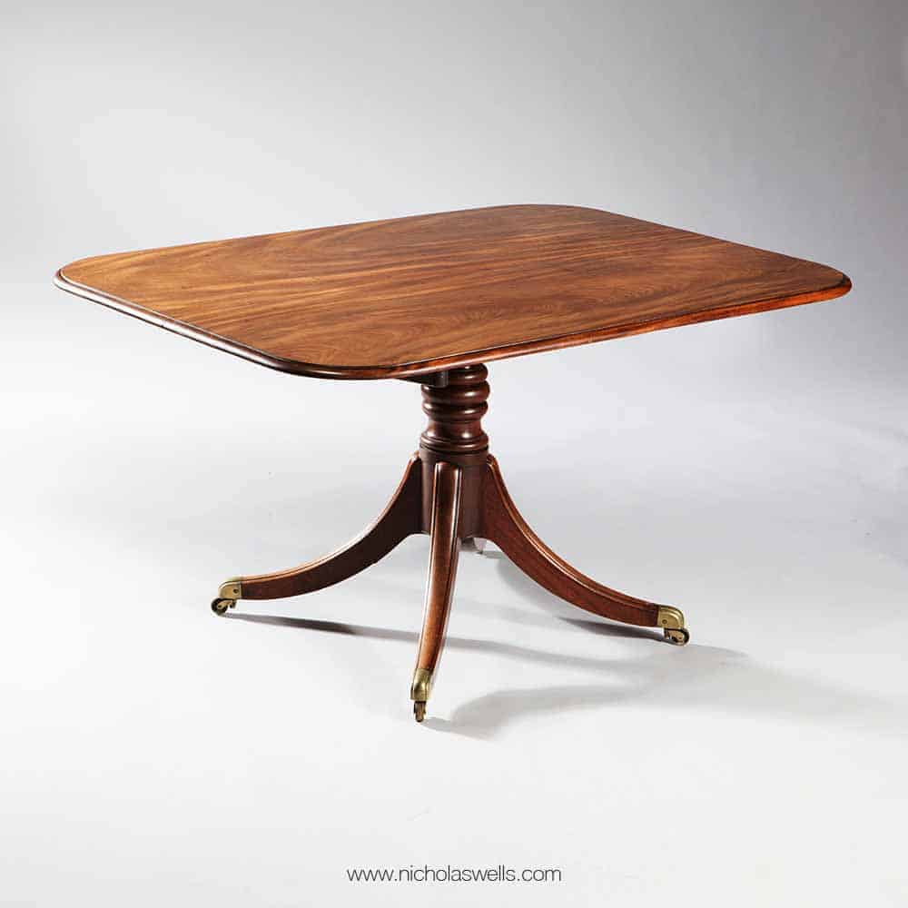 Elegant Georgian flame mahogany tilt-top dining table by The Sold Archive with turned column and four-legged base on casters