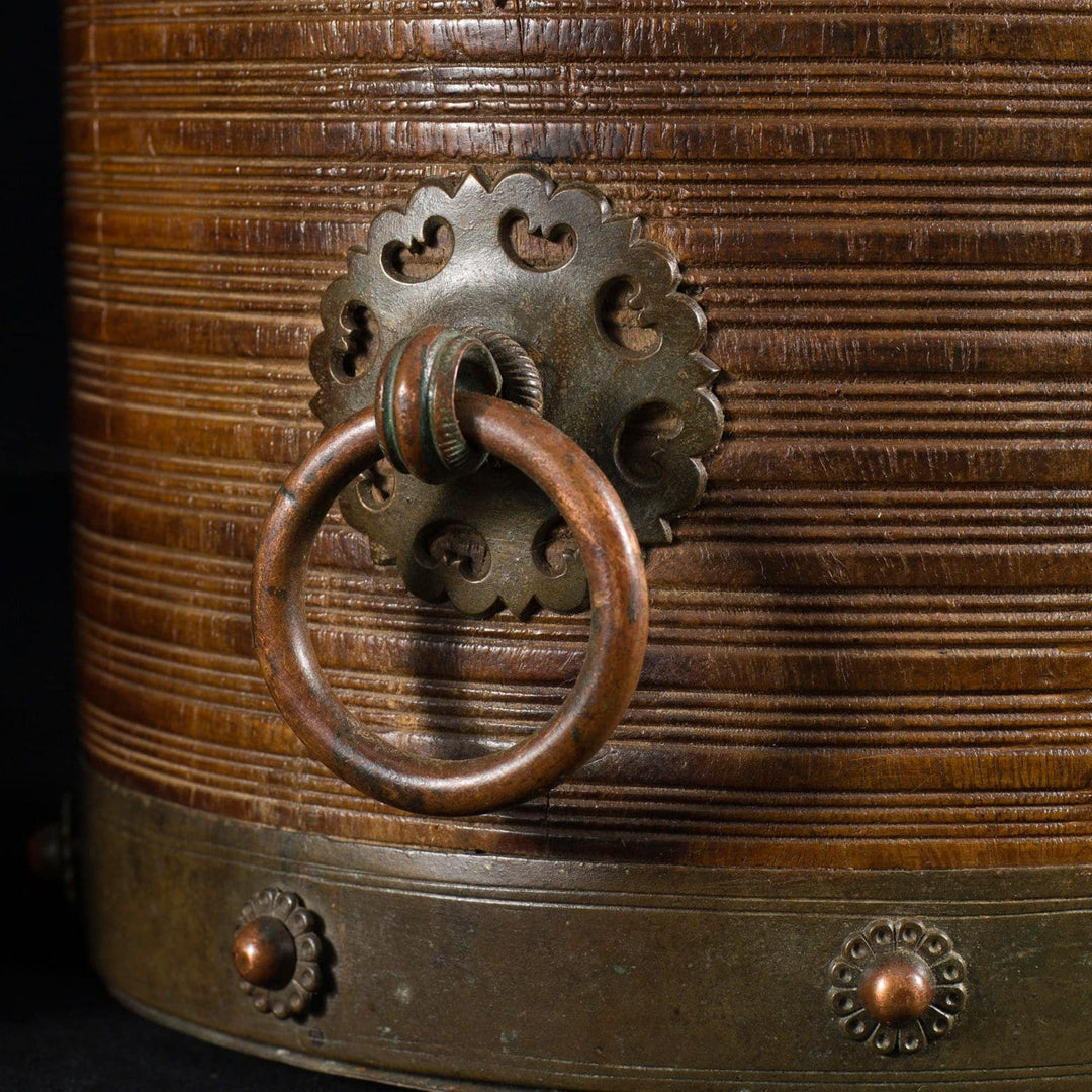 Close-up of brass bound handle and ribbed teak wood on Collection EE20 19th century Indian rice measure vessel