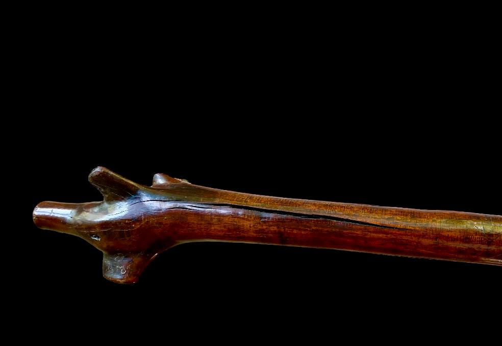 19th-century Fijian rootstock war club carved from hardwood displayed by Nwtiques on black background