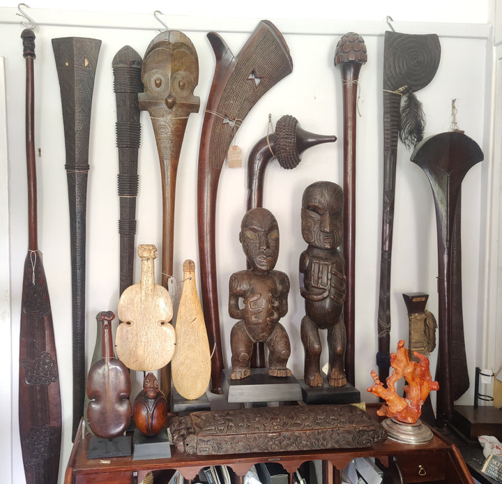Large Fijian Ironwood Sali War Club by Collection ON10 displayed among various Oceanic carved artifacts on shelf