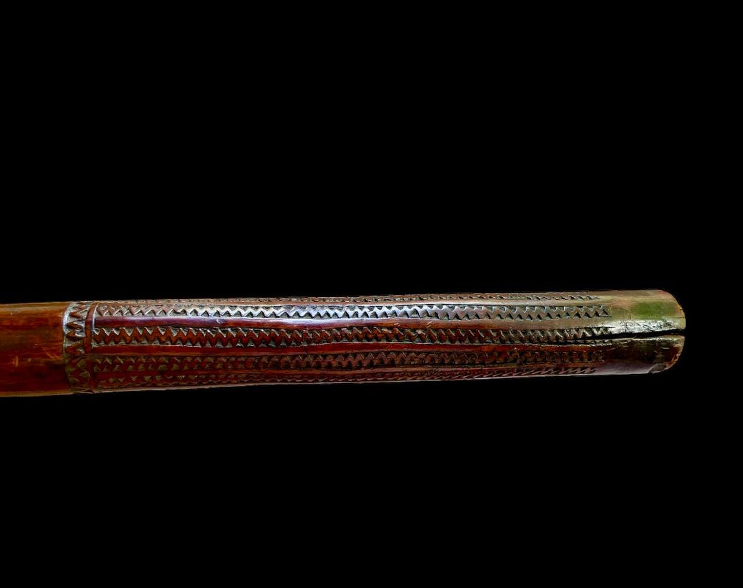 Detailed carved handle of a 19th-century Fijian rootstock war club from Nwtiques against black background