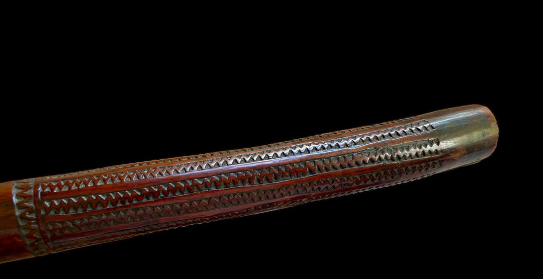 19th-century Fijian rootstock war club with intricate carvings by Nwtiques on black background