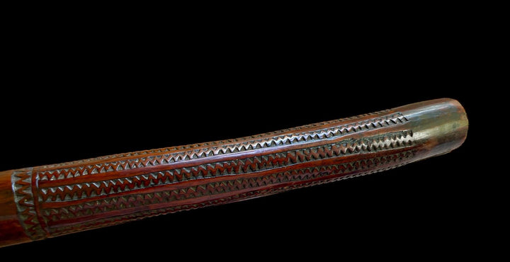 19th-century Fijian rootstock war club with intricate carvings by Nwtiques on black background