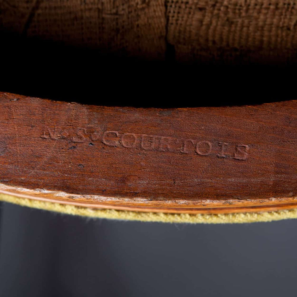 Close-up of the NS Courtois stamp on an 18th century fauteuil sold by Nwtiques