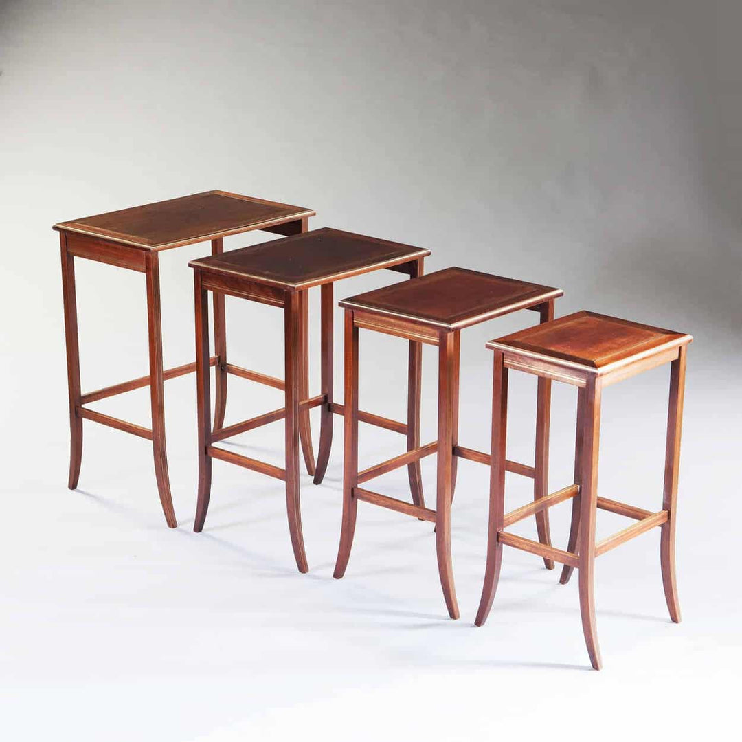 Nest of four antique mahogany tables with brass inlay and thumb moulded edges by The Sold Archive