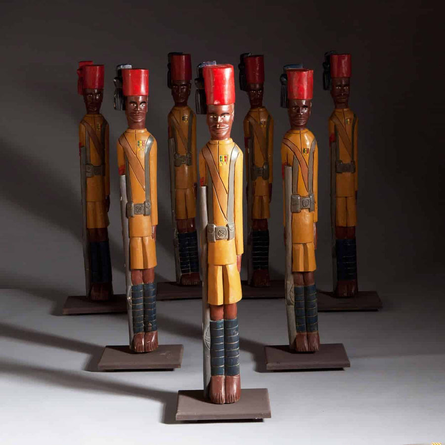 Carved wooden figures of Seven Kings African Rifles Soldiers in uniform by The Sold Archive displayed in formation