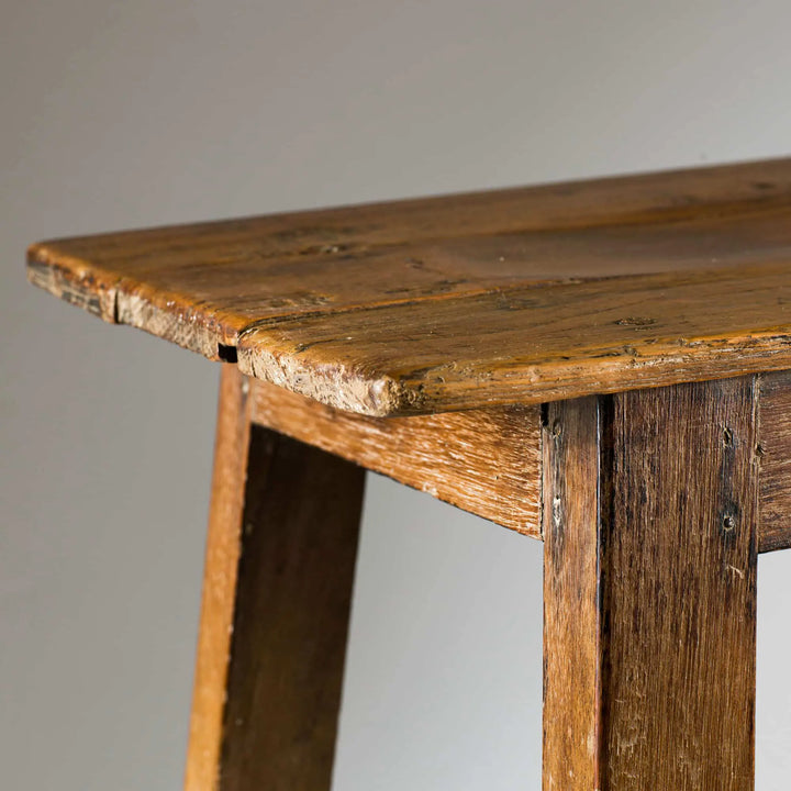 Close-up of 19th Century Indian Teak stool leg and edge showcasing aged patina by Collection EE30